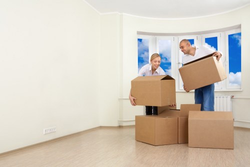Professional movers unloading items at a new property