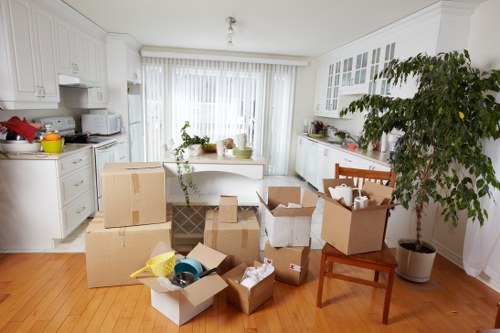 Moving team carrying office furniture through a commercial building in Tolworth